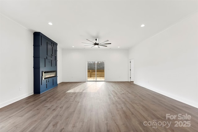 unfurnished living room featuring recessed lighting, wood finished floors, a ceiling fan, and baseboards