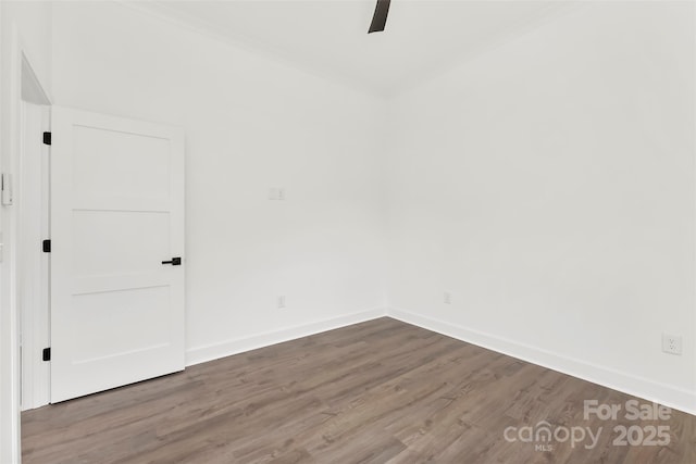 empty room with ceiling fan, wood finished floors, and baseboards