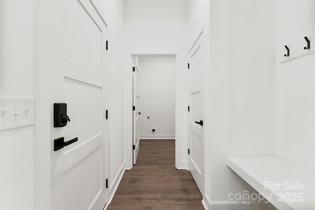 mudroom with dark wood-style floors and baseboards