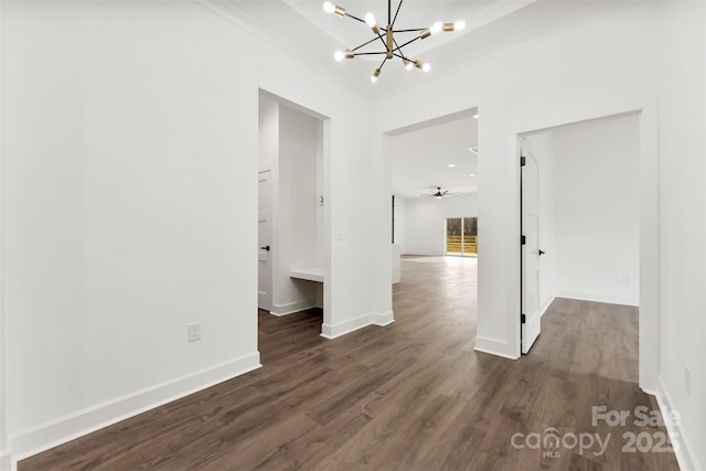 interior space featuring dark wood finished floors, baseboards, and ceiling fan with notable chandelier