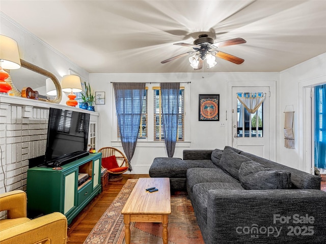 living room featuring dark wood finished floors and a ceiling fan