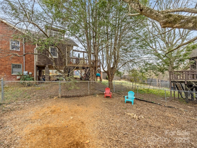 view of property's community featuring stairs, a deck, and a fenced backyard