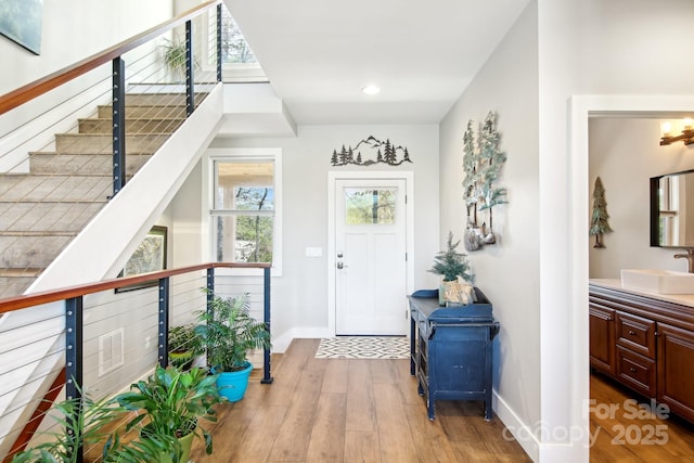 foyer with recessed lighting, baseboards, and wood finished floors