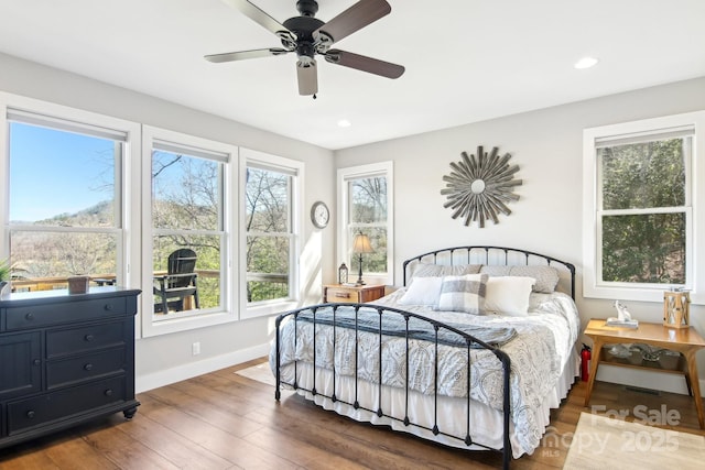 bedroom featuring a ceiling fan, baseboards, wood finished floors, and recessed lighting