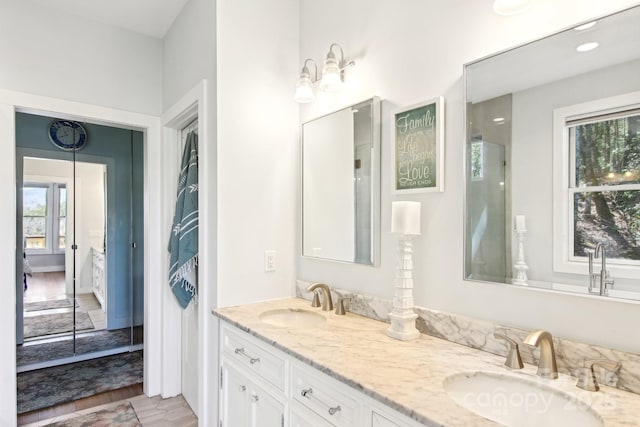 ensuite bathroom with ensuite bathroom, double vanity, and a sink