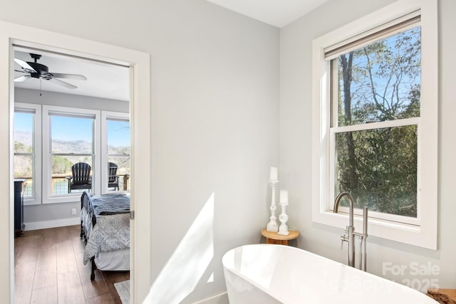 bedroom featuring wood finished floors and baseboards