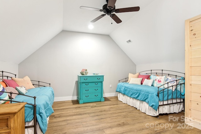 bedroom with visible vents, vaulted ceiling, ceiling fan, wood finished floors, and baseboards