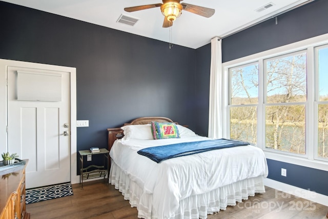 bedroom featuring a ceiling fan, baseboards, visible vents, and dark wood-style flooring