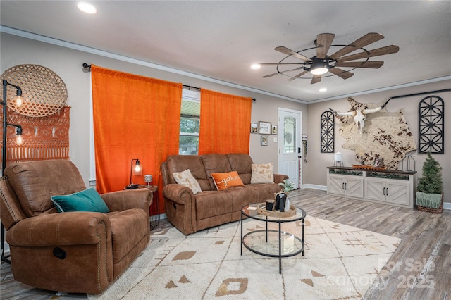 living room with recessed lighting, crown molding, light wood-style flooring, and baseboards