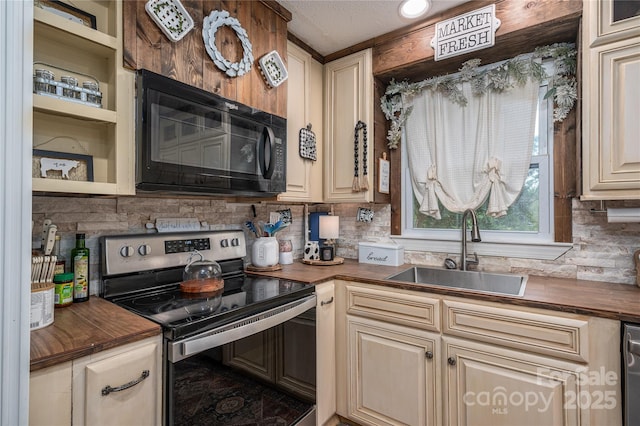 kitchen featuring black microwave, wooden counters, a sink, and stainless steel electric stove