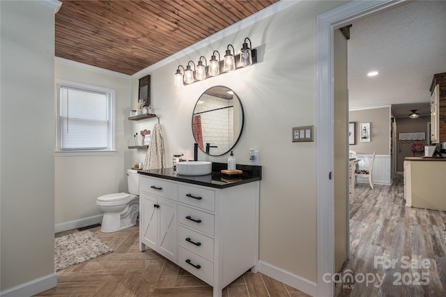 bathroom featuring wooden ceiling, toilet, wood finished floors, vanity, and crown molding