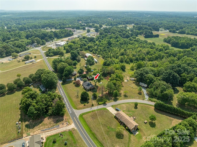 birds eye view of property with a rural view