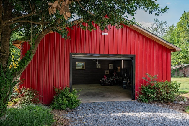 detached garage with gravel driveway