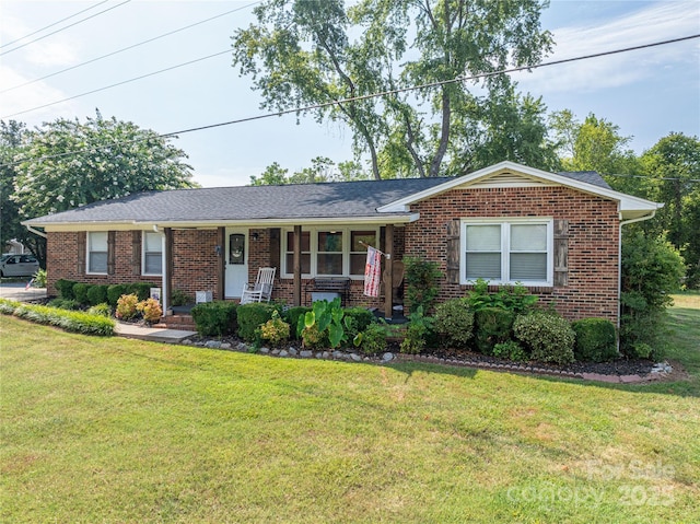 ranch-style house with covered porch, a front lawn, and brick siding