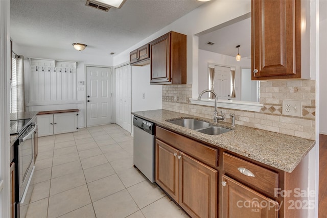 11000 White Stag Dr, Charlotte, NC 28269 - kitchen with appliances with stainless steel finishes, tasteful backsplash, light stone countertops, and a textured ceiling