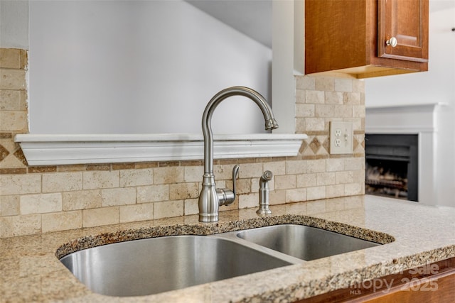 11000 White Stag Dr, Charlotte, NC 28269 - kitchen view of tasteful backsplash, brown cabinets, and a fireplace