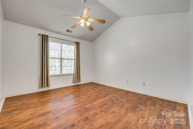11000 White Stag Dr, Charlotte, NC 28269 - empty room featuring vaulted ceiling, wood finished floors, a ceiling fan, and a textured ceiling