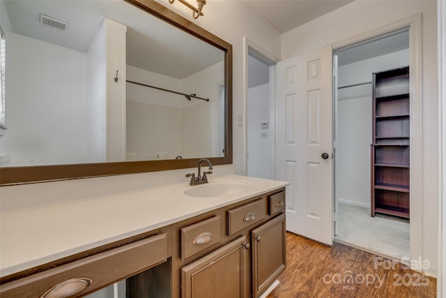 11000 White Stag Dr, Charlotte, NC 28269 - bathroom with vanity, wood finished floors, and a shower