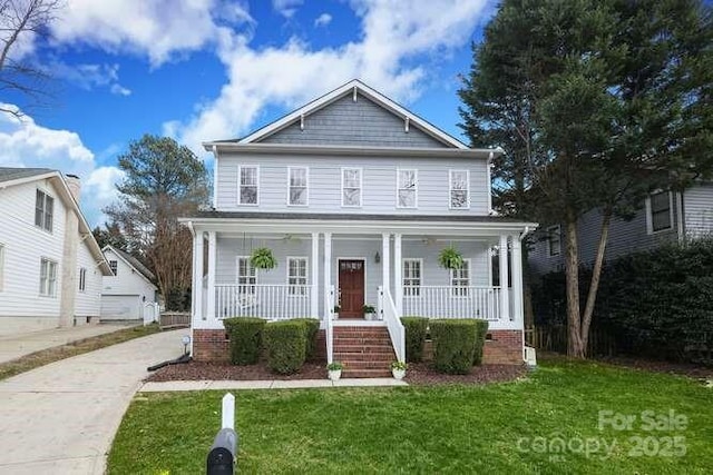 view of front of property with a front yard and covered porch