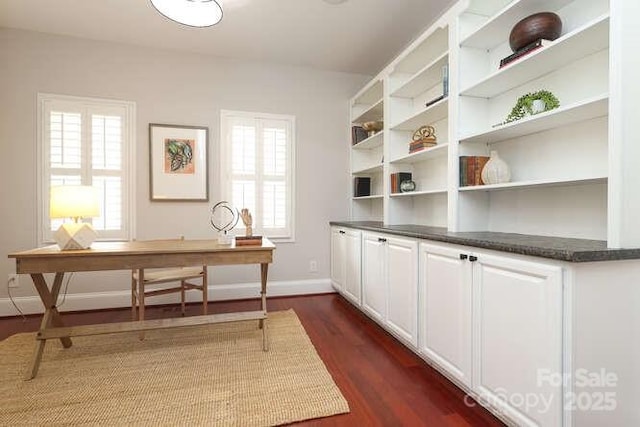 office space with dark wood-type flooring and baseboards