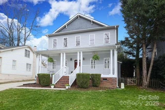 view of front of house featuring a porch, a front yard, crawl space, and fence