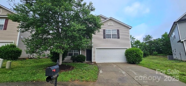 view of front of property featuring an attached garage, concrete driveway, and a front yard