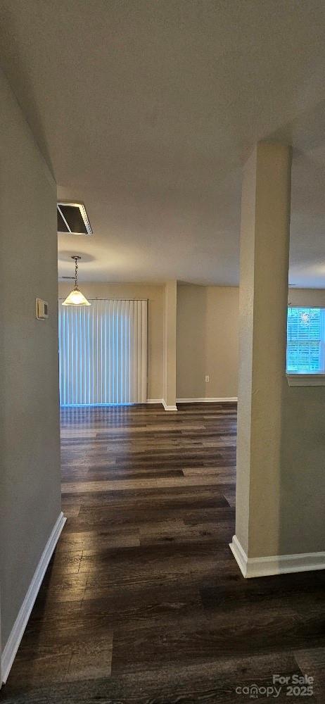 empty room with baseboards and wood finished floors
