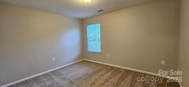 carpeted empty room with baseboards