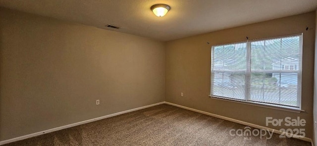 unfurnished room with carpet floors and baseboards