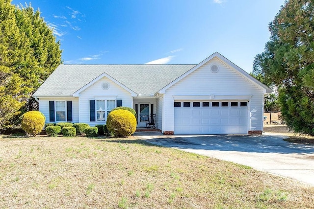 ranch-style house featuring a garage, a front lawn, concrete driveway, and roof with shingles