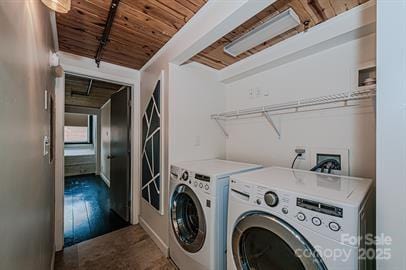 laundry area with laundry area, wooden ceiling, and washer and clothes dryer