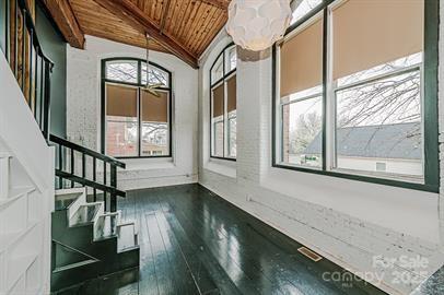 interior space featuring stairs, wooden ceiling, vaulted ceiling with beams, and wood-type flooring