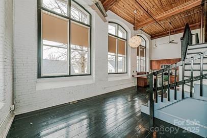 interior space featuring beam ceiling, wood ceiling, and hardwood / wood-style floors