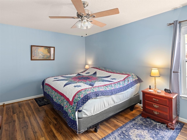 bedroom featuring a ceiling fan, baseboards, and wood finished floors