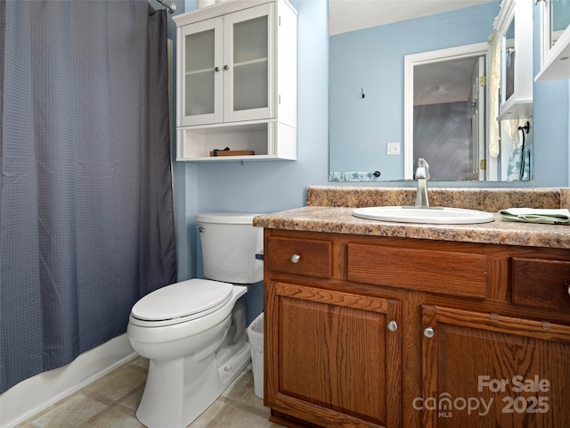 full bath featuring vanity, toilet, and tile patterned floors