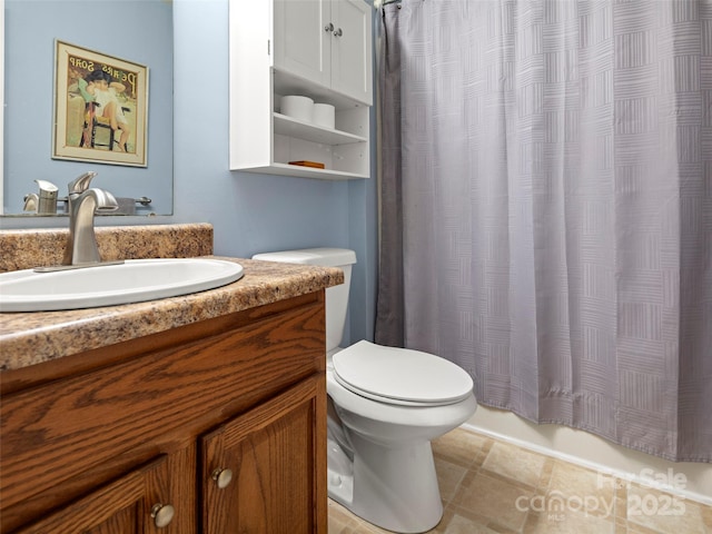 bathroom with tile patterned flooring, vanity, and toilet