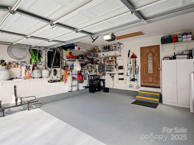 garage featuring a workshop area and a garage door opener