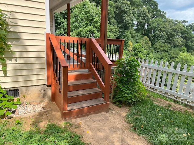 wooden terrace featuring stairs and fence