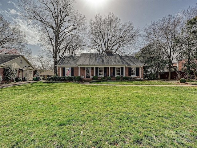 view of front facade featuring a front yard and brick siding