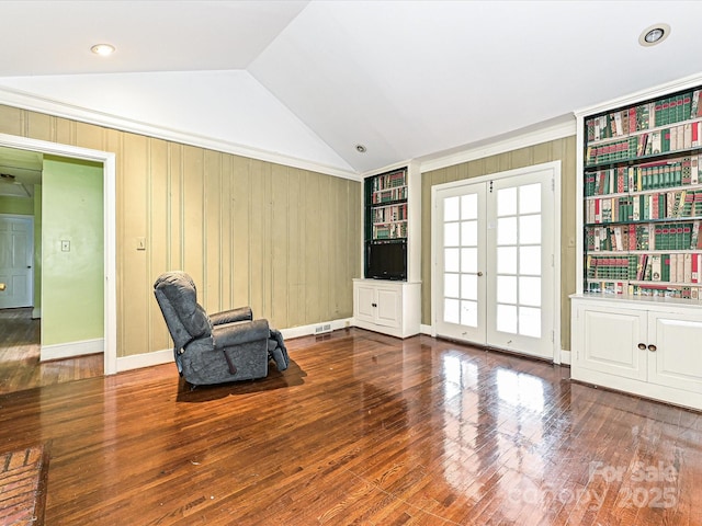 unfurnished room featuring vaulted ceiling, french doors, hardwood / wood-style flooring, and baseboards