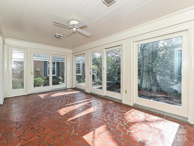 unfurnished sunroom with a ceiling fan