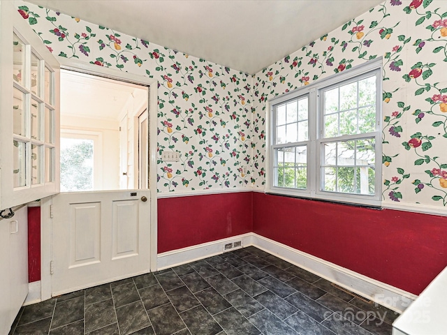 entrance foyer with baseboards, visible vents, and wallpapered walls