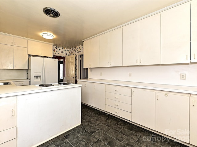 kitchen featuring light countertops, white appliances, and visible vents