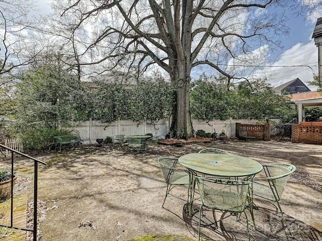 view of yard with a patio area, a fenced backyard, and outdoor dining area