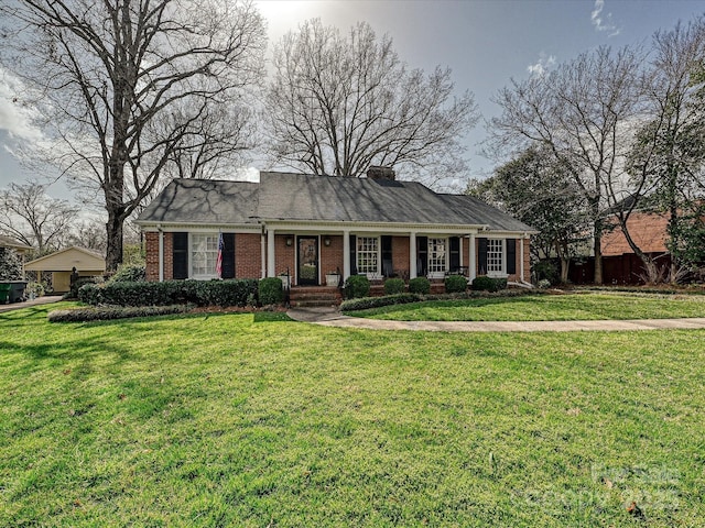 view of front of house with brick siding and a front yard