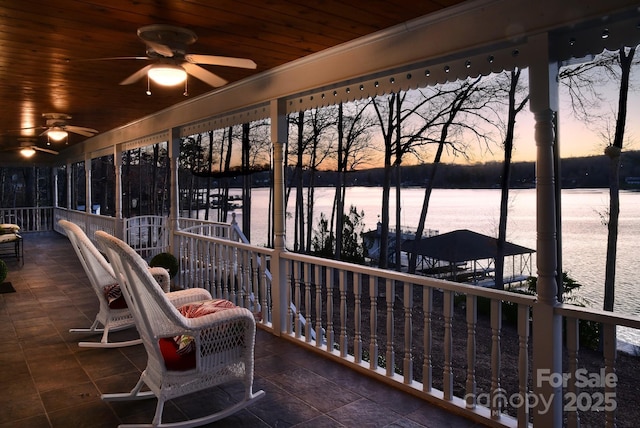 sunroom featuring wooden ceiling and ceiling fan