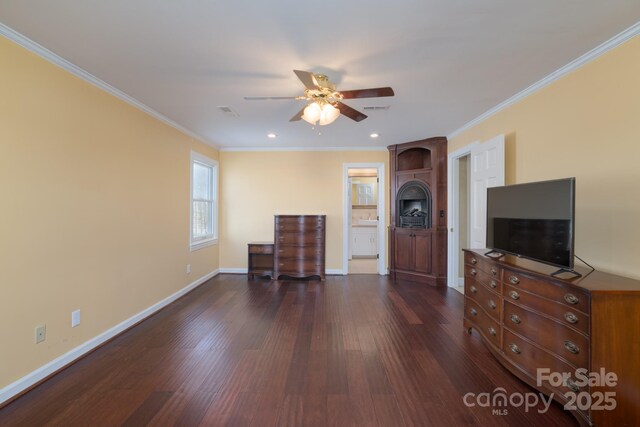 unfurnished living room with dark wood-style flooring, visible vents, crown molding, and baseboards