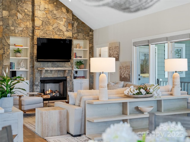 living area featuring a fireplace and high vaulted ceiling