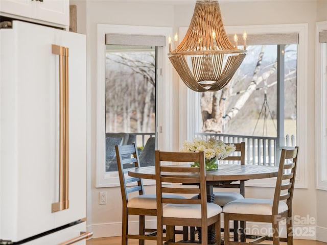 dining area with baseboards and a chandelier