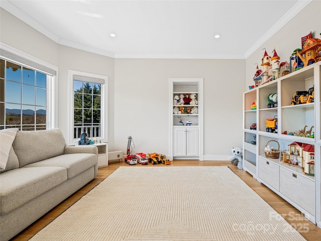 recreation room featuring recessed lighting, light wood-style floors, and ornamental molding